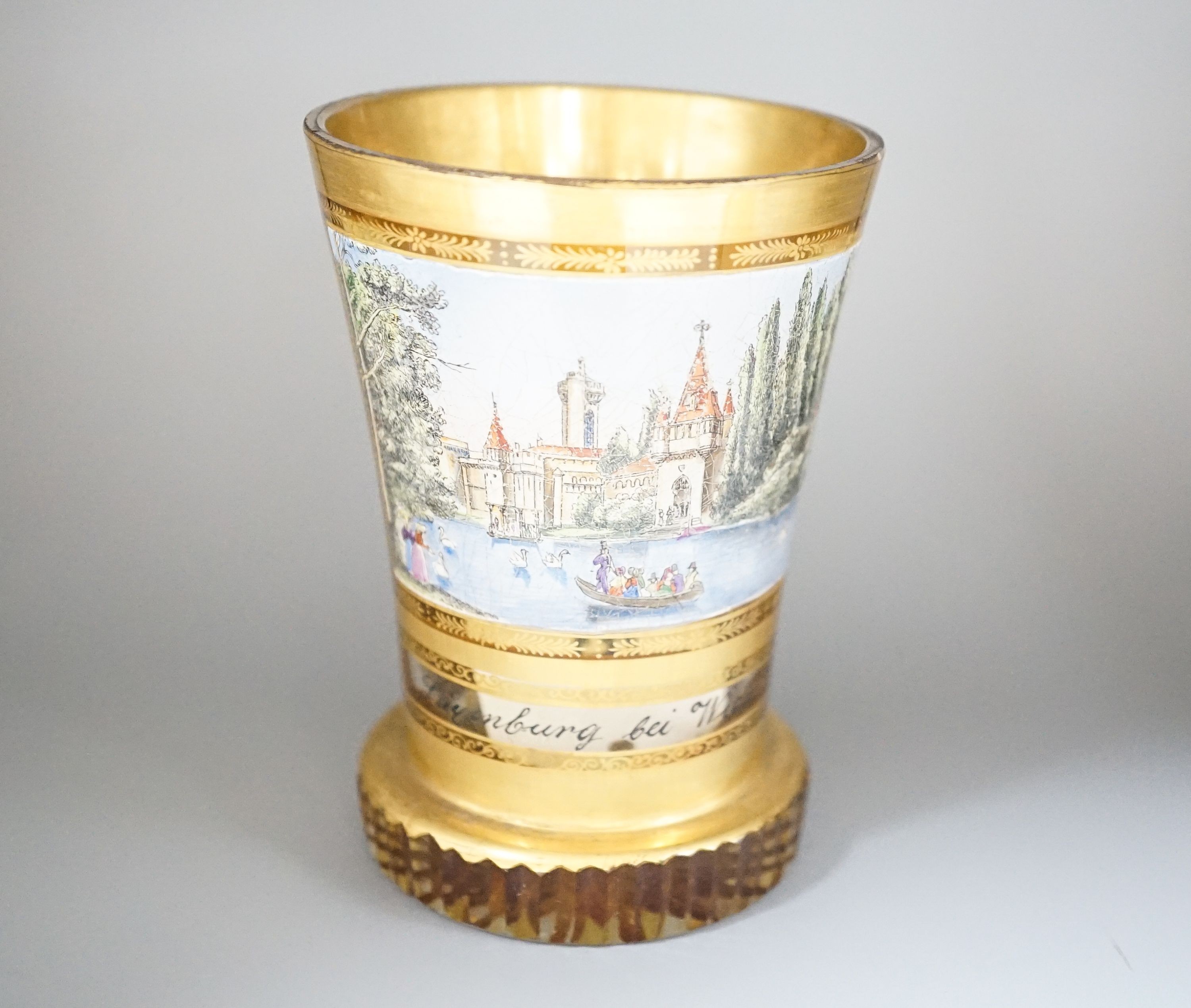 A 19th century Bohemian enamelled and gilded glass beaker 11cm, with titled scene Layenburg bei Wien